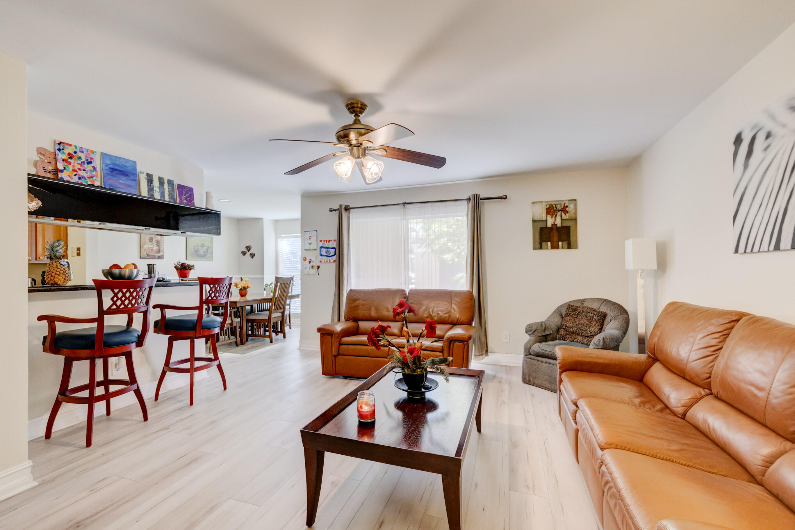 995 Riverside Drive, Unit 111 Coral Springs, FL 33071 - Photo 3 of 24 a living room with furniture kitchen view and a window