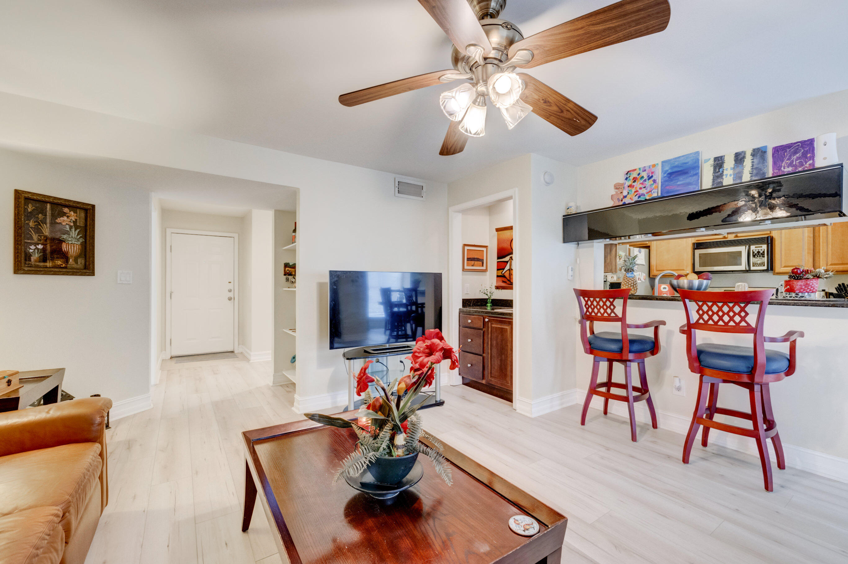 995 Riverside Drive, Unit 111 Coral Springs, FL 33071 - Photo 5 of 24 a living room with furniture and a flat screen tv