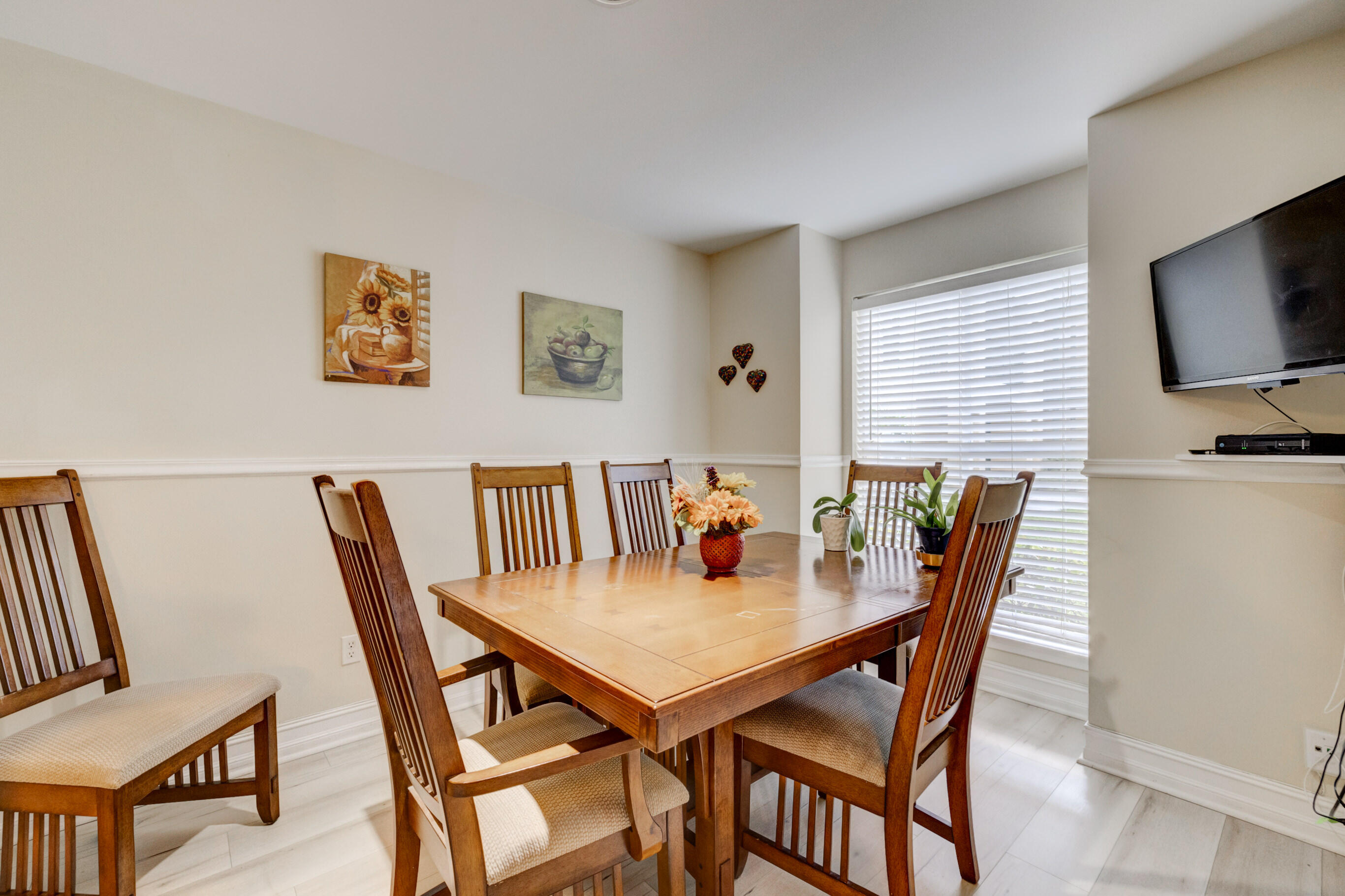 995 Riverside Drive, Unit 111 Coral Springs, FL 33071 - Photo 7 of 24 a view of a dining room with furniture and wooden floor