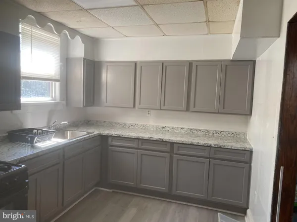 a kitchen with a sink and cabinets