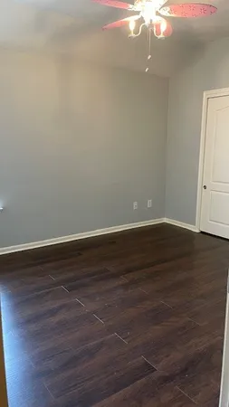 a view of a room with wooden floor