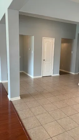 an empty room with wooden floor