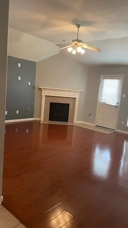 a view of a livingroom with a ceiling fan and window