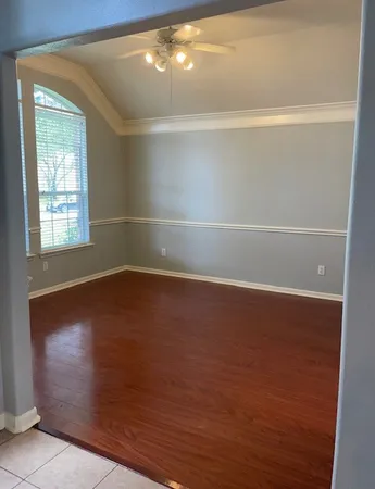 a view of room with window and wooden floor