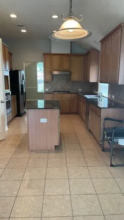 a kitchen with stainless steel appliances a sink a counter and stove
