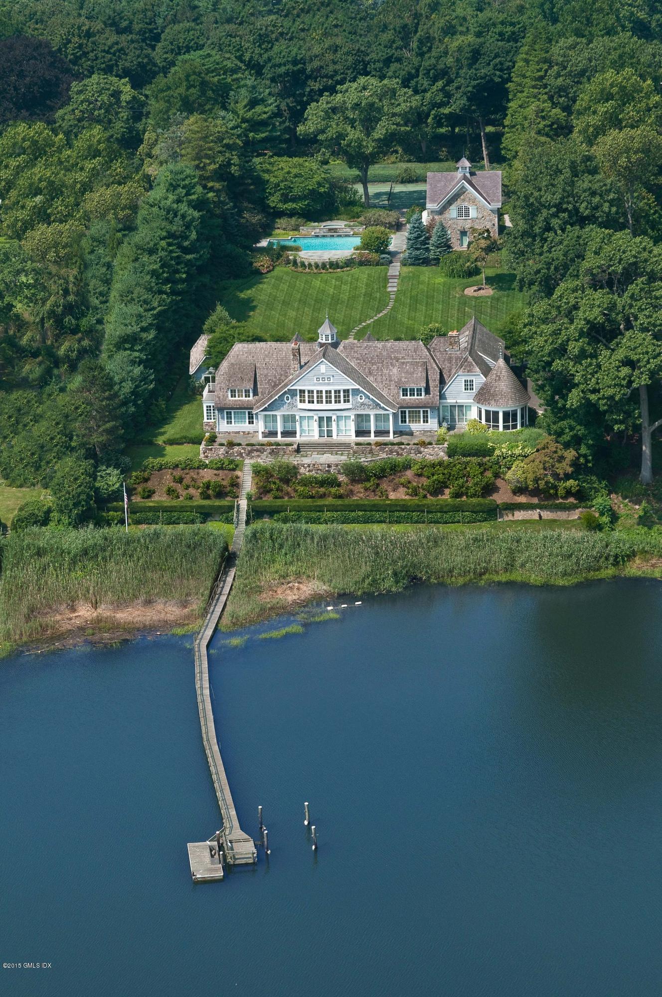 141 Long Neck Point Road Darien, CT 06820 - Photo 2 of 7 a view of a lake with a house in the background