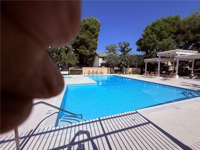 a view of a swimming pool with a patio