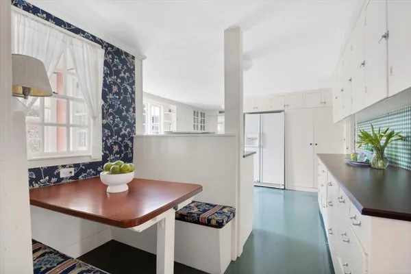 a kitchen with a refrigerator a sink and cabinets