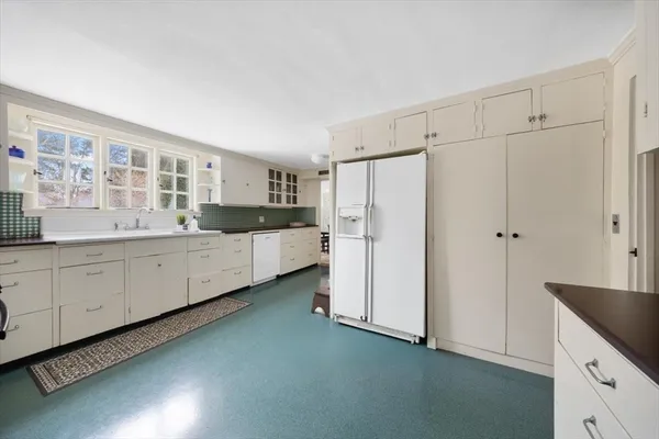 a bathroom with a sink a mirror and a window