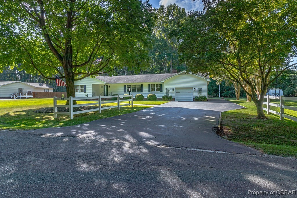 35 Powhatan Road Kilmarnock, VA 22482 - Photo 41 of 42 Ranch-style house with a front yard, driveway, a garage, and fence