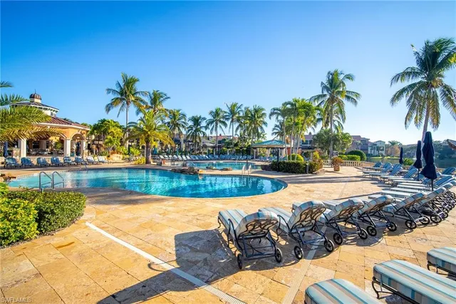 a view of swimming pool with outdoor seating and plants