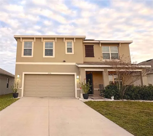 a front view of a house with a yard and garage