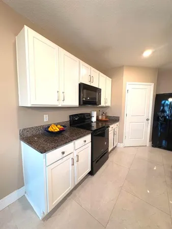 a kitchen with a sink a refrigerator and window