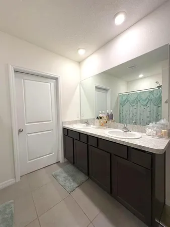 a bathroom with a toilet sink and shower