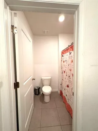 a large bed sitting in a bedroom next to a window