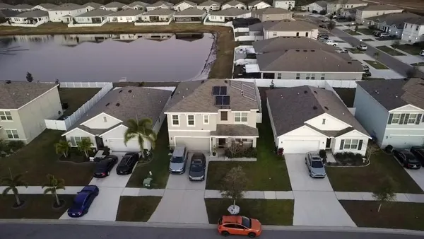 an aerial view of residential house with outdoor space and swimming pool