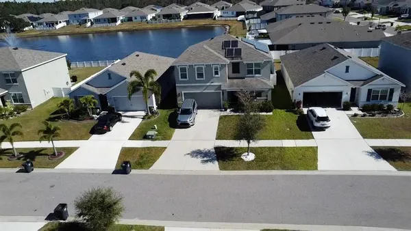 an aerial view of a house with a swimming pool