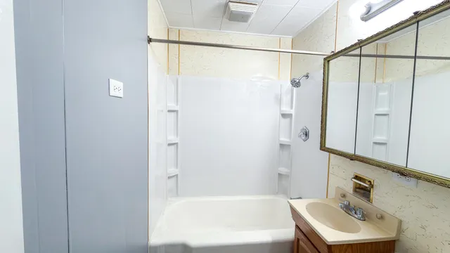 a bathroom with a shower and a sink