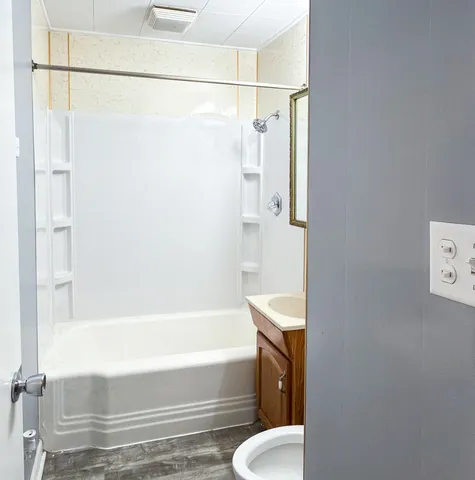 a bathroom with a shower and a toilet