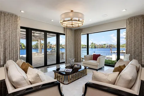 a living room with furniture and large windows