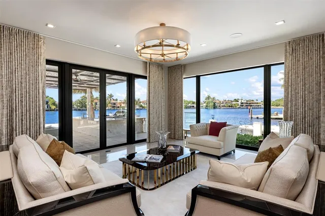 a living room with furniture and large windows