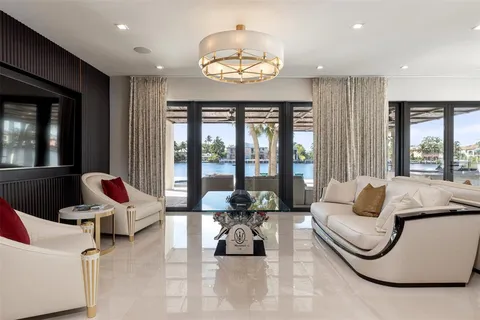 a view of a livingroom with furniture and floor to ceiling window