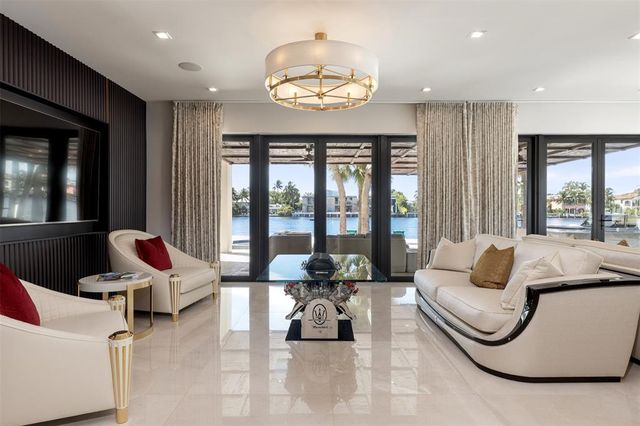a view of a livingroom with furniture and floor to ceiling window