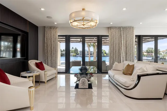 a view of a livingroom with furniture and floor to ceiling window