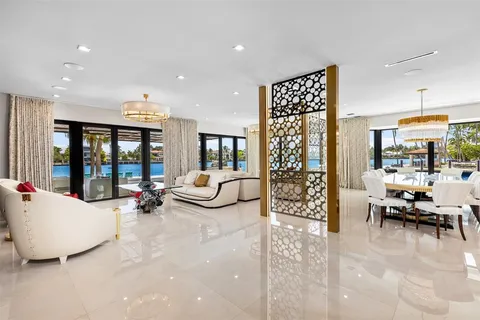 a living room with furniture and large windows