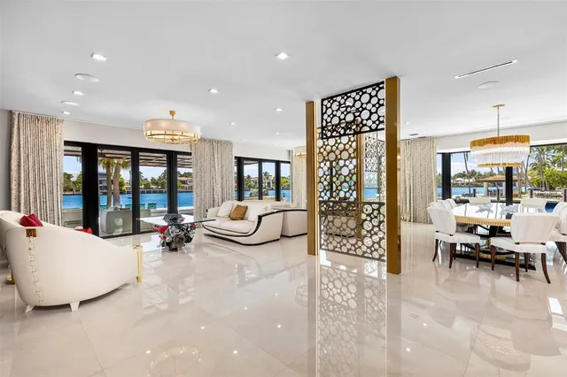 a living room with furniture and large windows