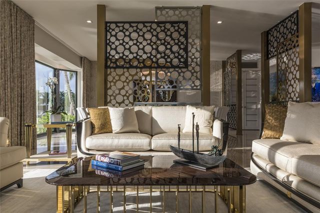 a dining room with furniture a chandelier and window