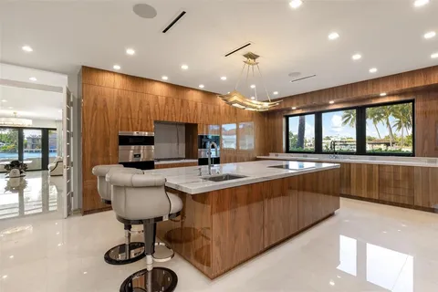 a kitchen with stainless steel appliances kitchen island granite countertop a sink and cabinets
