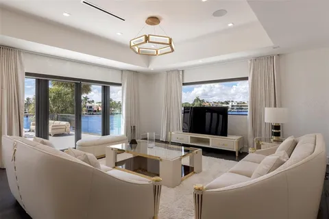 a spacious bedroom with a bed couch and large window