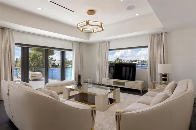 a spacious bedroom with a bed couch and large window