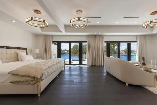 a spacious bathroom with a double vanity sink a toilet a mirror and shower