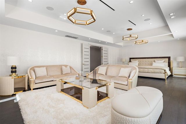 a spacious bedroom with a bed and large window