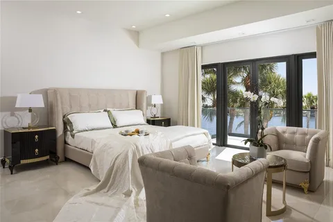 a view of swimming pool with lake view and trees in the background