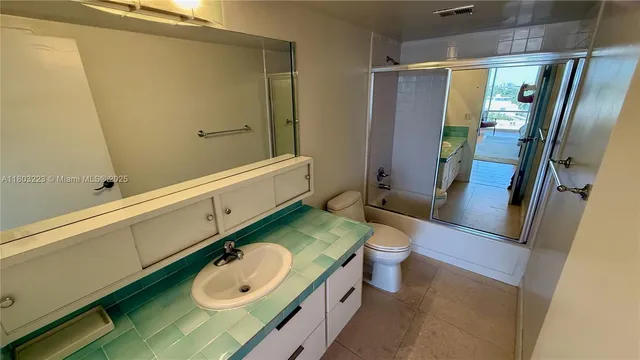 a bedroom with a bed lamp and a large window