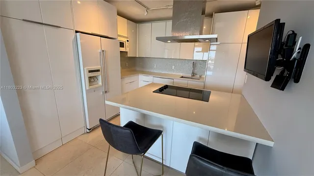 a kitchen with stainless steel appliances a refrigerator and a stove top oven