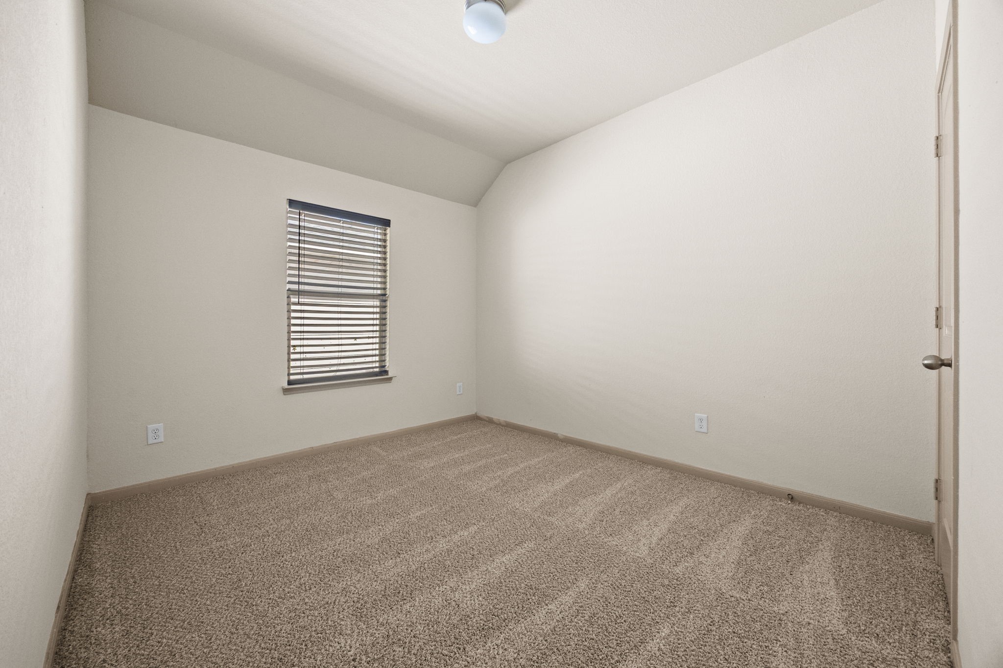 3606 Canvasback Lane Houston, TX 77047 - Photo 21 of 29 Comfortable secondary bedroom with fresh carpet, vaulted ceiling, and a large window that fills the room with natural light. Located upstairs.