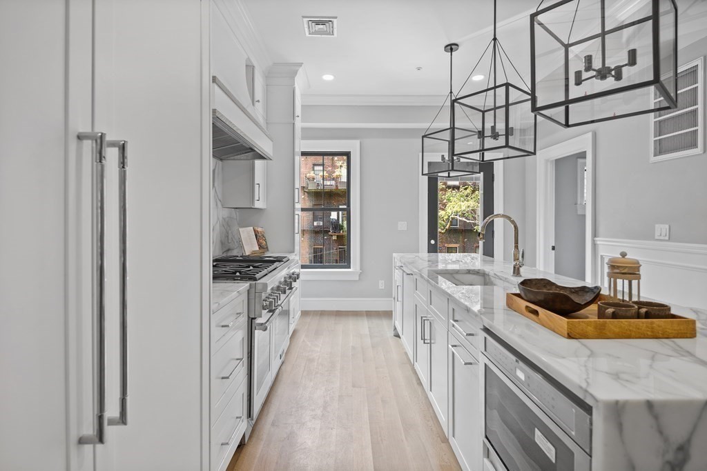 210 West Springfield Street, Unit 2 Boston, MA 02118 - Photo 15 of 33 a kitchen with stainless steel appliances granite countertop a sink stove and refrigerator