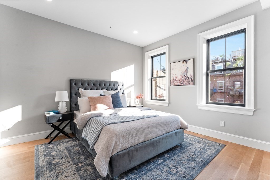 210 West Springfield Street, Unit 2 Boston, MA 02118 - Photo 26 of 33 a bedroom with a bed and wooden floor