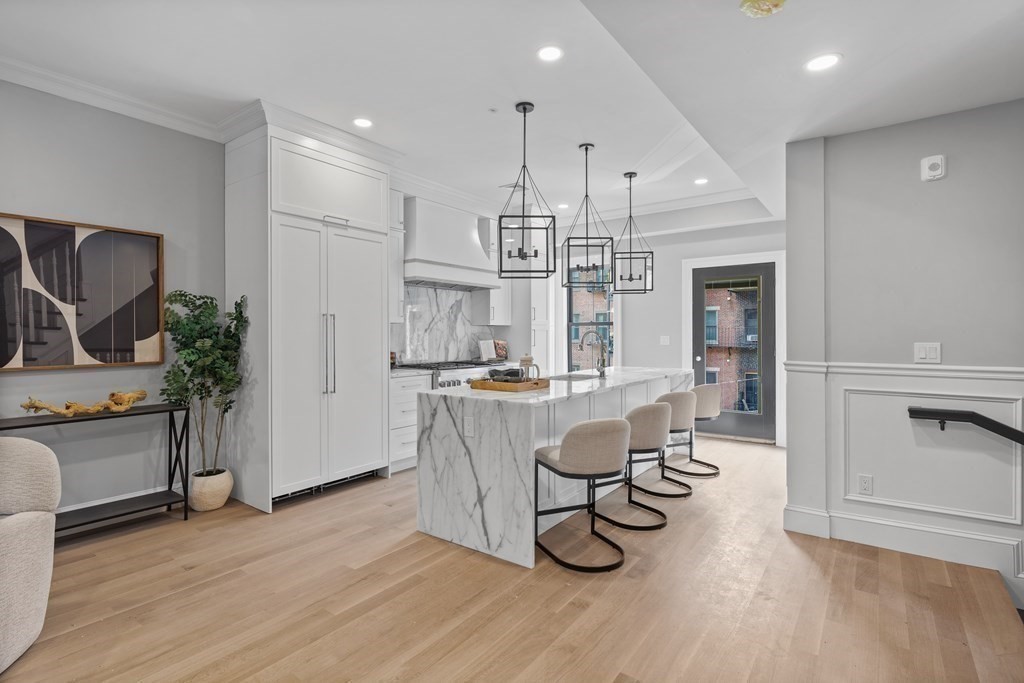 210 West Springfield Street, Unit 2 Boston, MA 02118 - Photo 9 of 33 a very nice looking kitchen with granite countertop a large counter top space a sink stainless steel appliances and cabinets