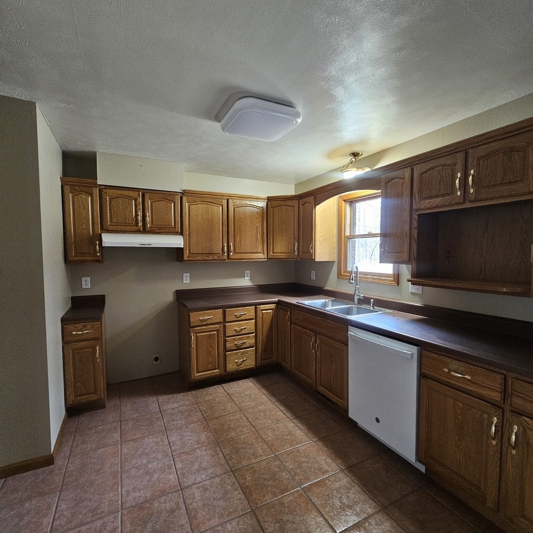 11211 Sam Pyle Bridge Road Benton, IL 62812 - Photo 3 of 11 a kitchen with stainless steel appliances granite countertop a sink stove and oven
