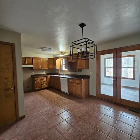 a kitchen with stainless steel appliances granite countertop a sink counter top space cabinets and stainless steel appliances