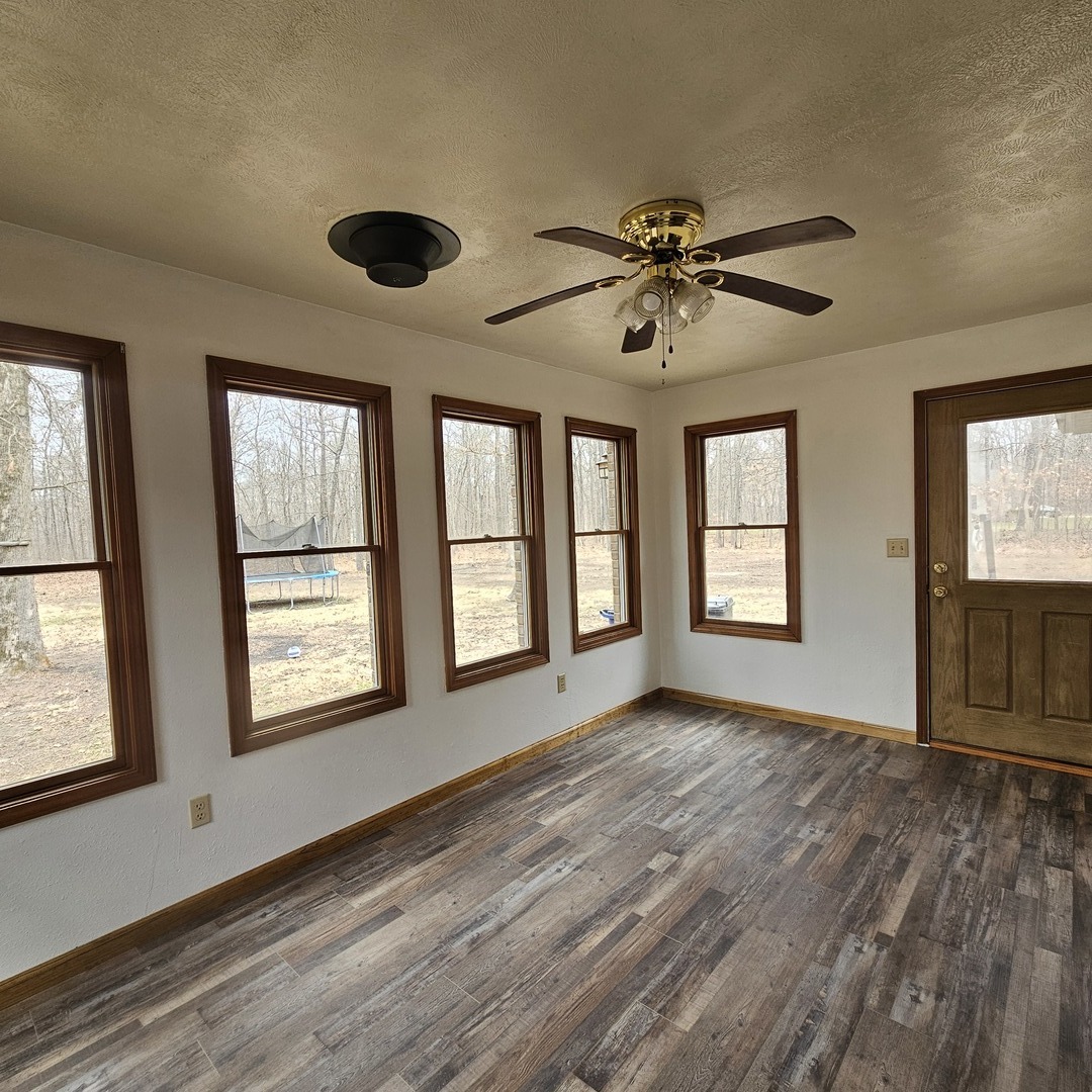 11211 Sam Pyle Bridge Road Benton, IL 62812 - Photo 5 of 11 a view of an empty room with a window and wooden floor