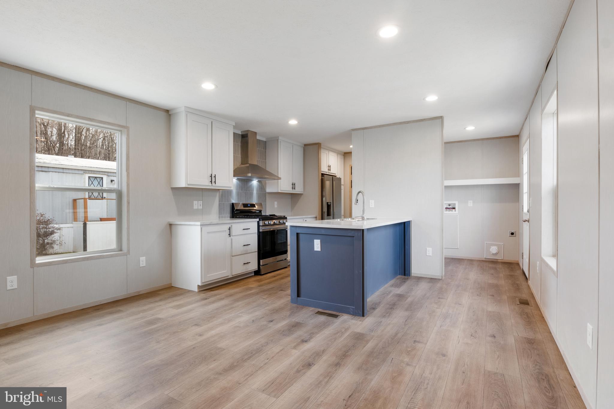9 Mill Street York, PA 17406 - Photo 4 of 32 a large kitchen with stainless steel appliances granite countertop a large counter top a wooden floors and a window