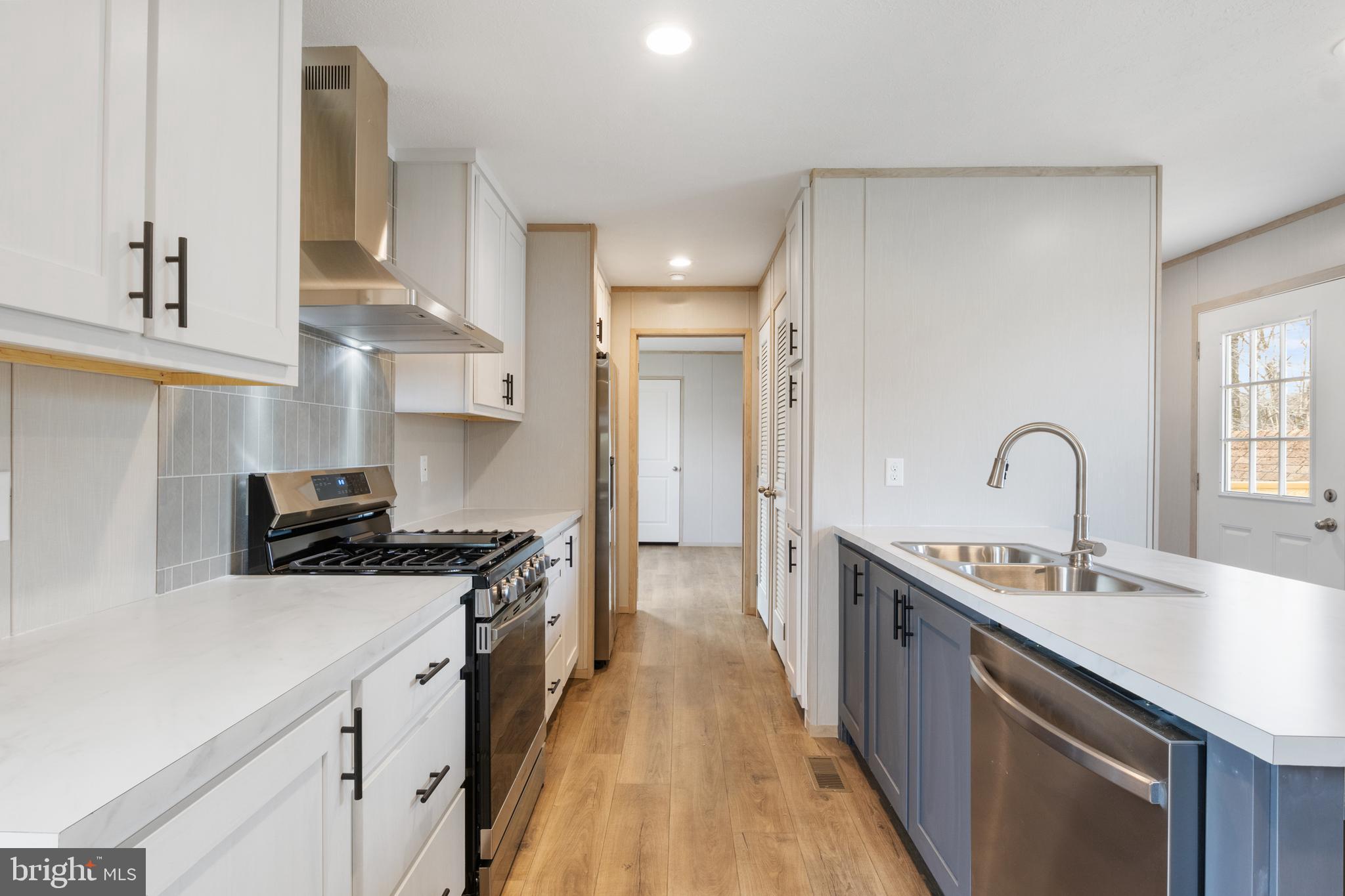 9 Mill Street York, PA 17406 - Photo 6 of 32 a kitchen with kitchen island a sink stove and cabinets