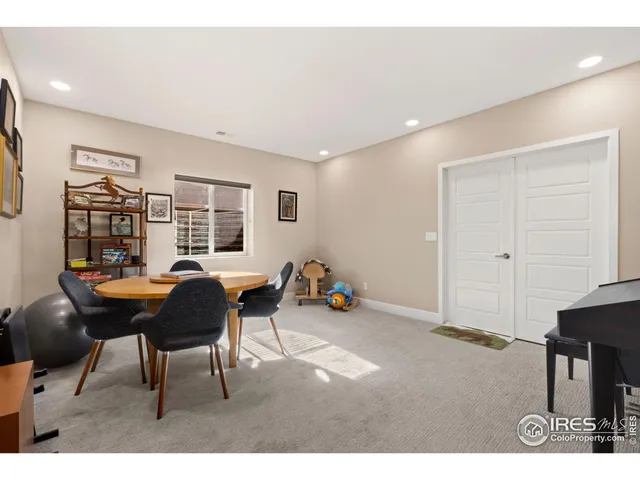a living room with furniture and a dining table