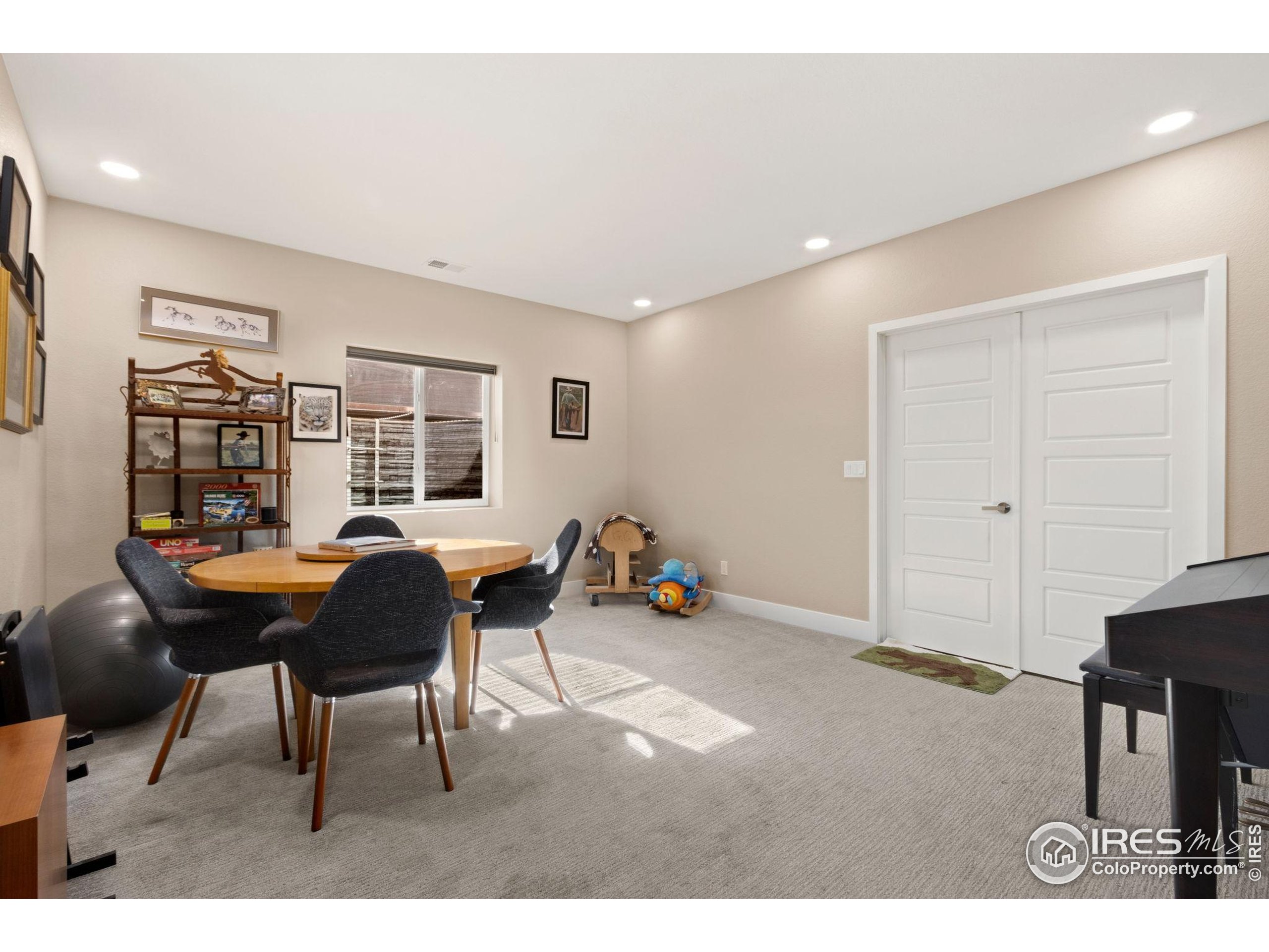 6808 Castello Street Timnath, CO 80547 - Photo 16 of 22 a living room with furniture and a dining table